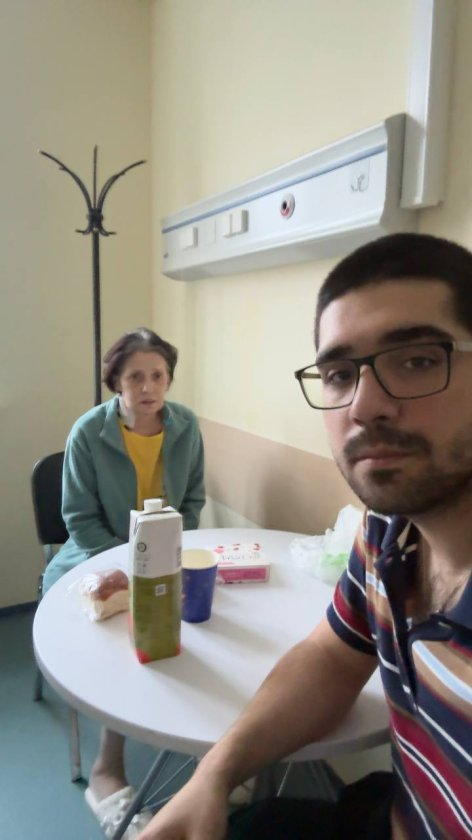 Совместная фотография мамы и мужчины за столом в больничной палате